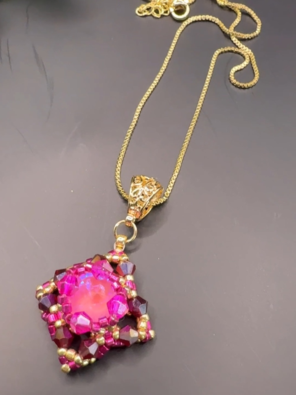 Gold-Tone Necklace with Vibrant Pink Crystal Pendant